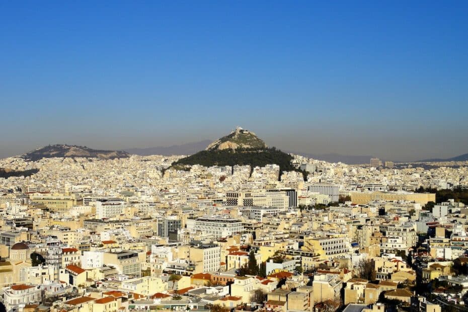 Blick auf die Stadt Athen mit der Akropolis im Hintergrund und einer klaren blauen Himmel.