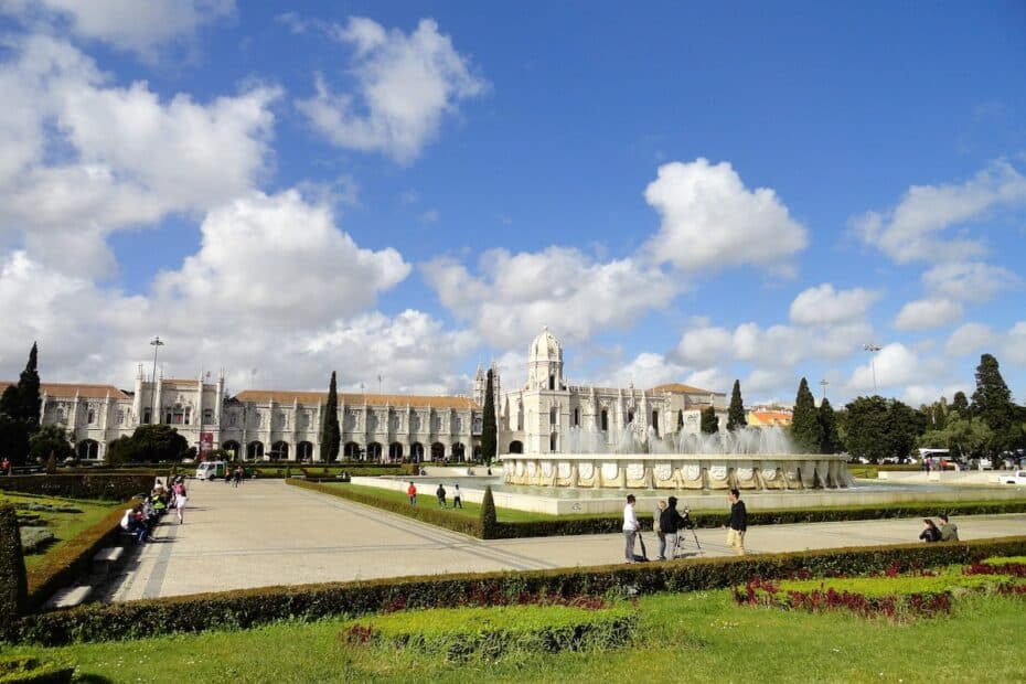 Das Kloster von Jerónimos in Lissabon mit einer großen Wasserfontäne im Vordergrund.