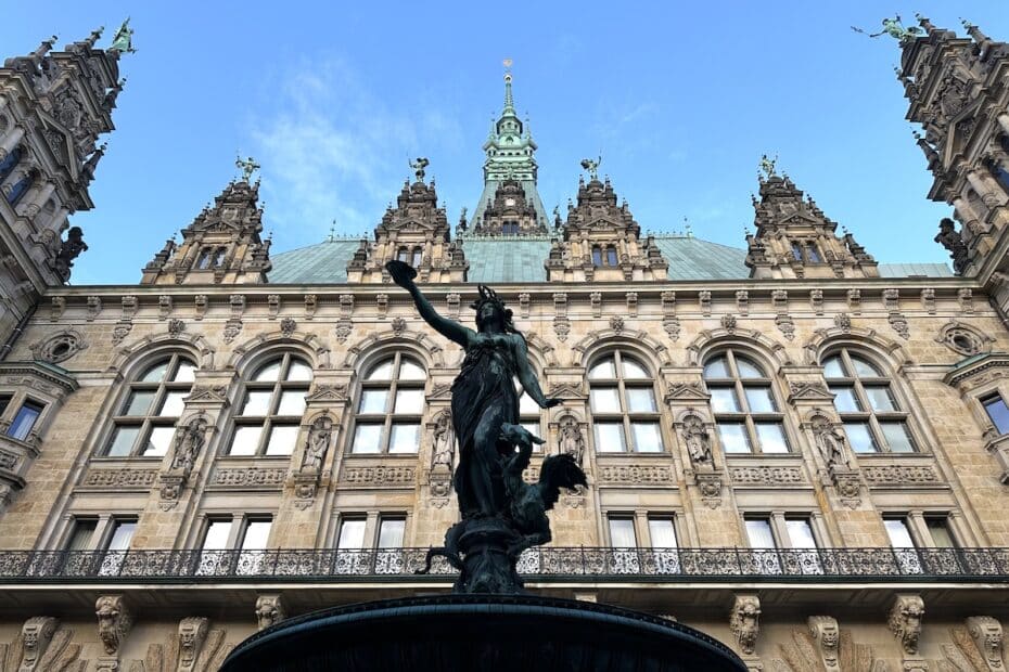 Brunnen mit einer Statue einer Frau, die eine Fackel hält, vor dem Hamburger Rathaus.